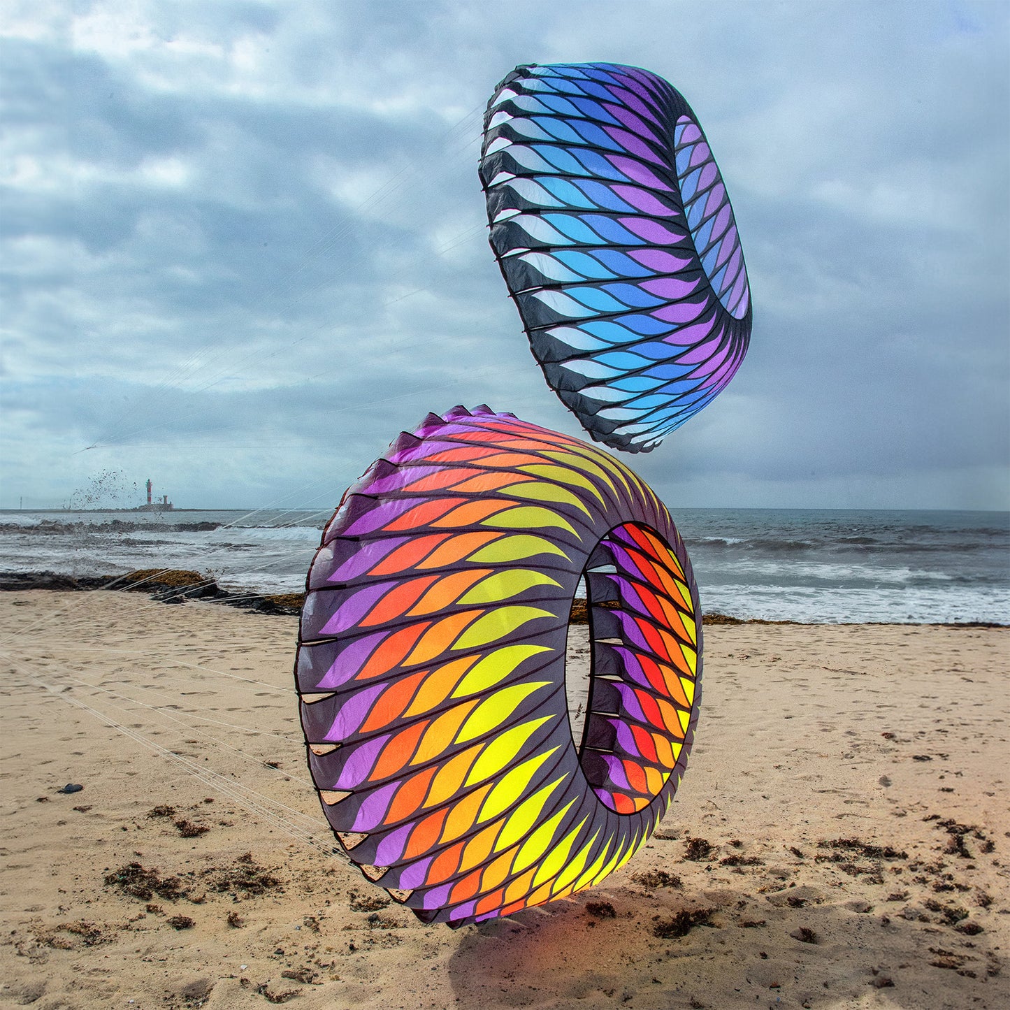 Two colorful bols on a sandy beach with ocean and sky in the background