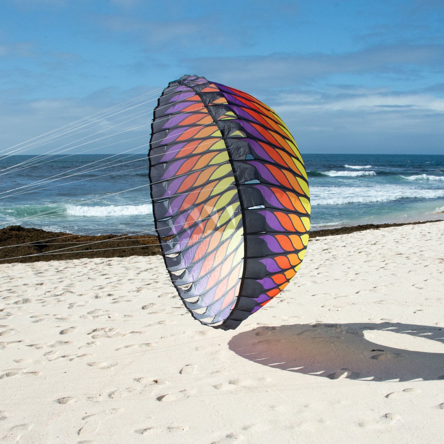 Colorful bol on a sandy beach with ocean in the background
