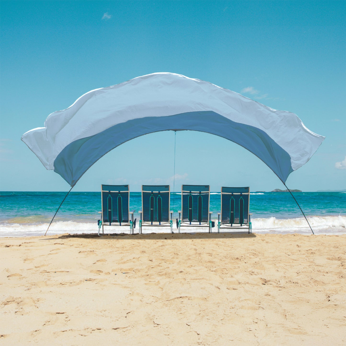 Beach shade on a sandy beach with ocean and clear blue sky in the background