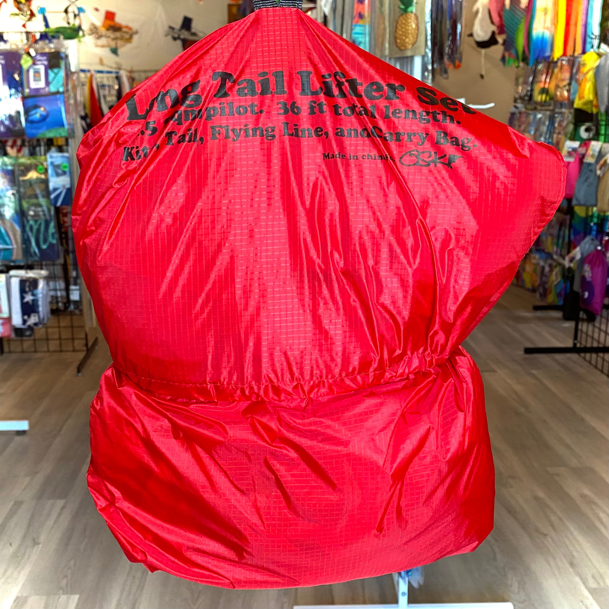 Red bag with text on a stand in a store setting