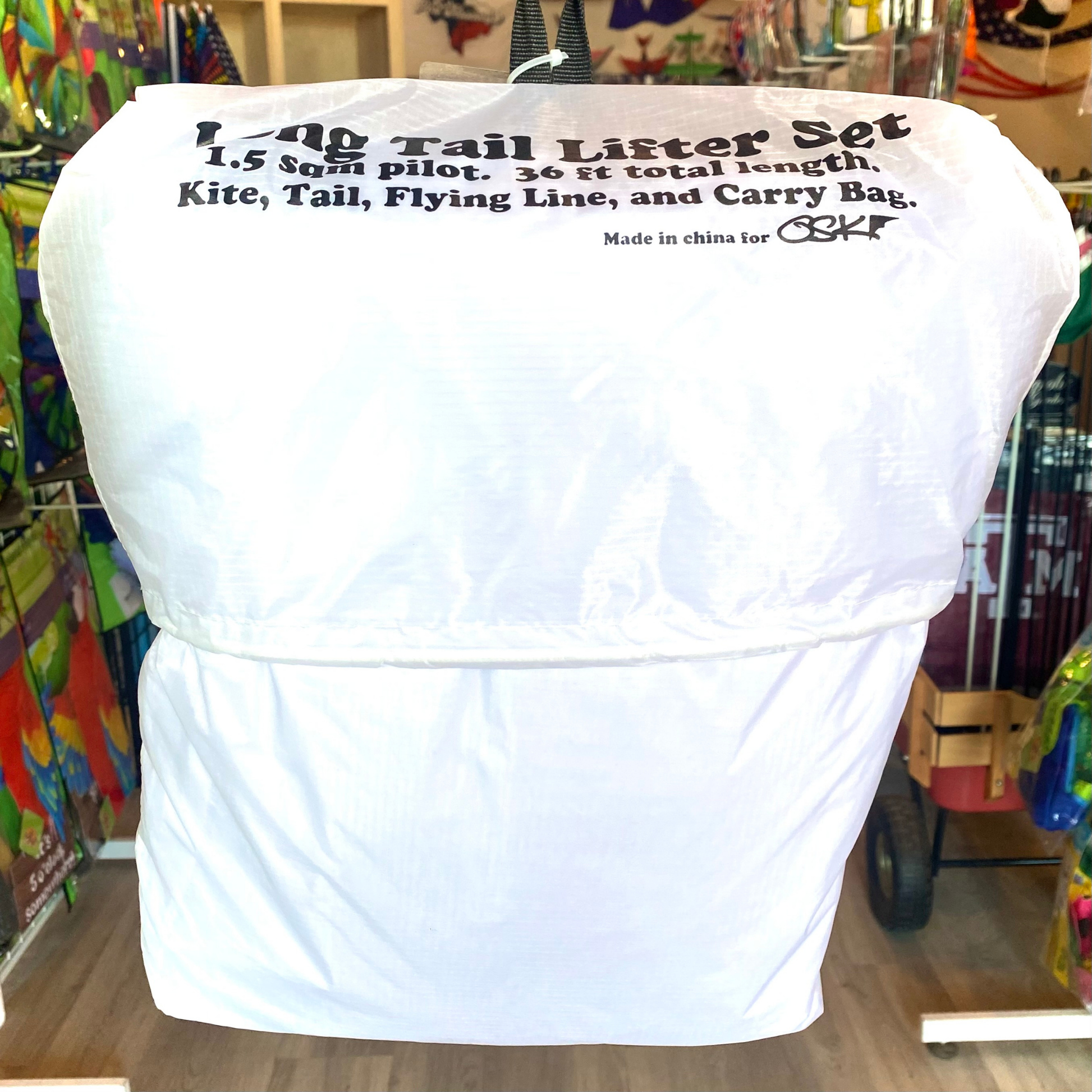 White kite carrying bag with text in a store setting
