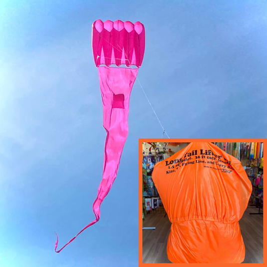 Pink kite tail with an inset of an orange kite bag on a blue sky background