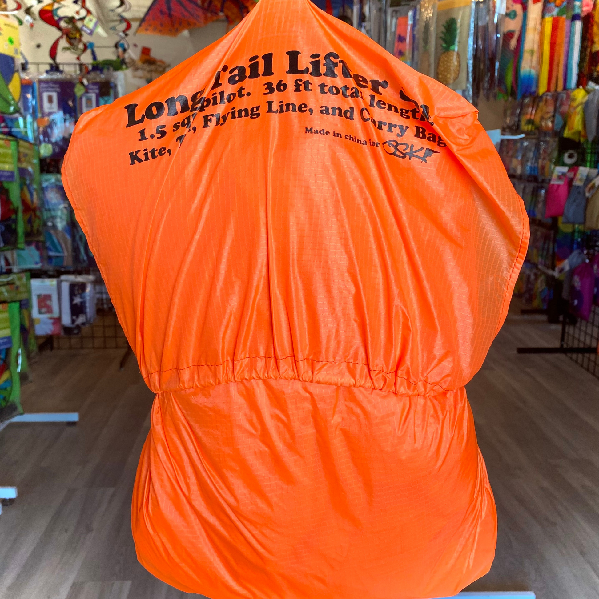 Orange kite with text in a store