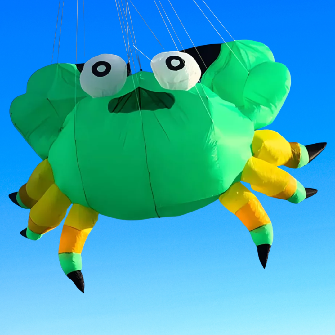 Colorful kite shaped like a green crab with yellow legs against a clear blue sky.