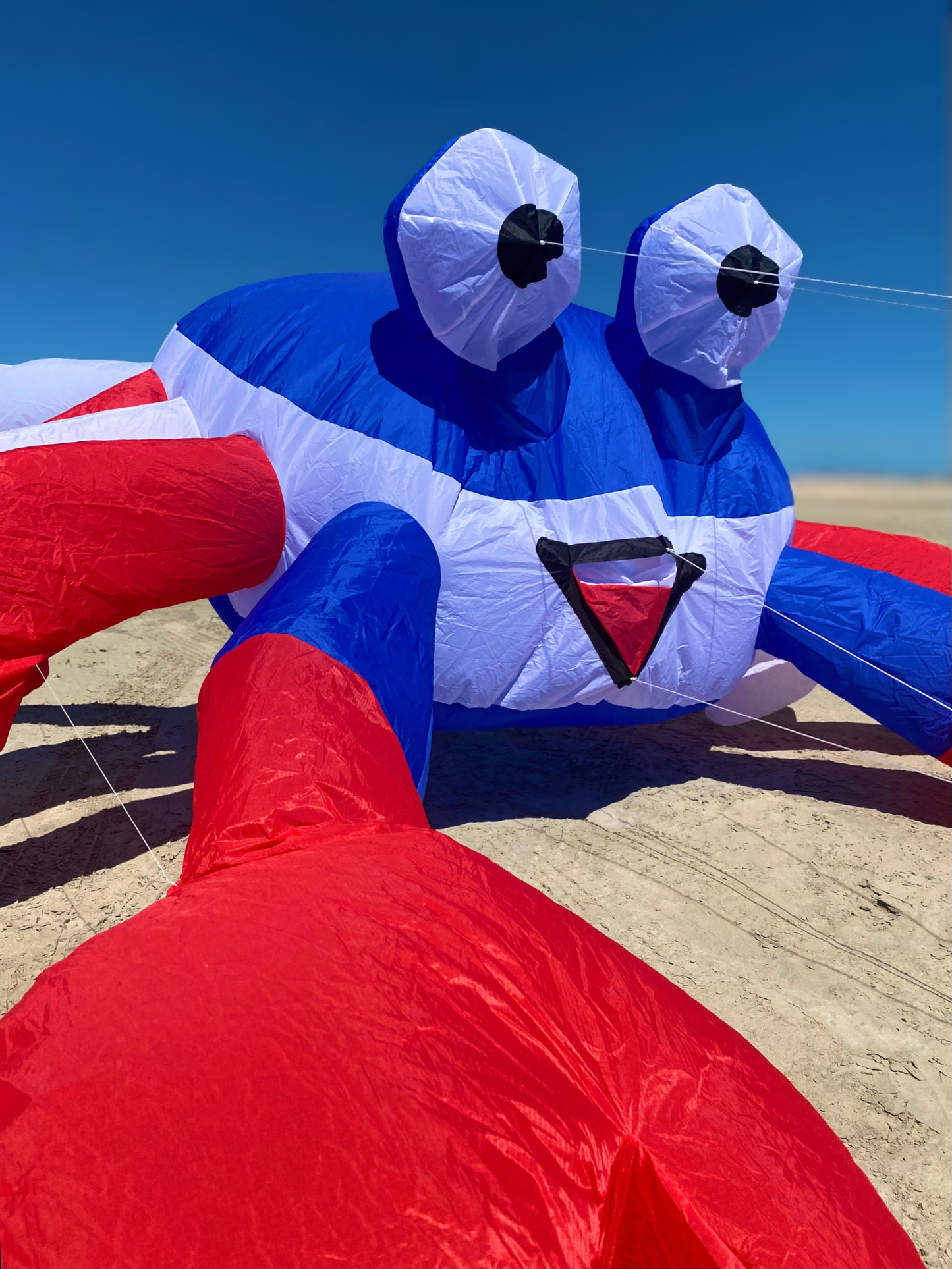 Inflatable crab with red, white, and blue colors on a clear day.