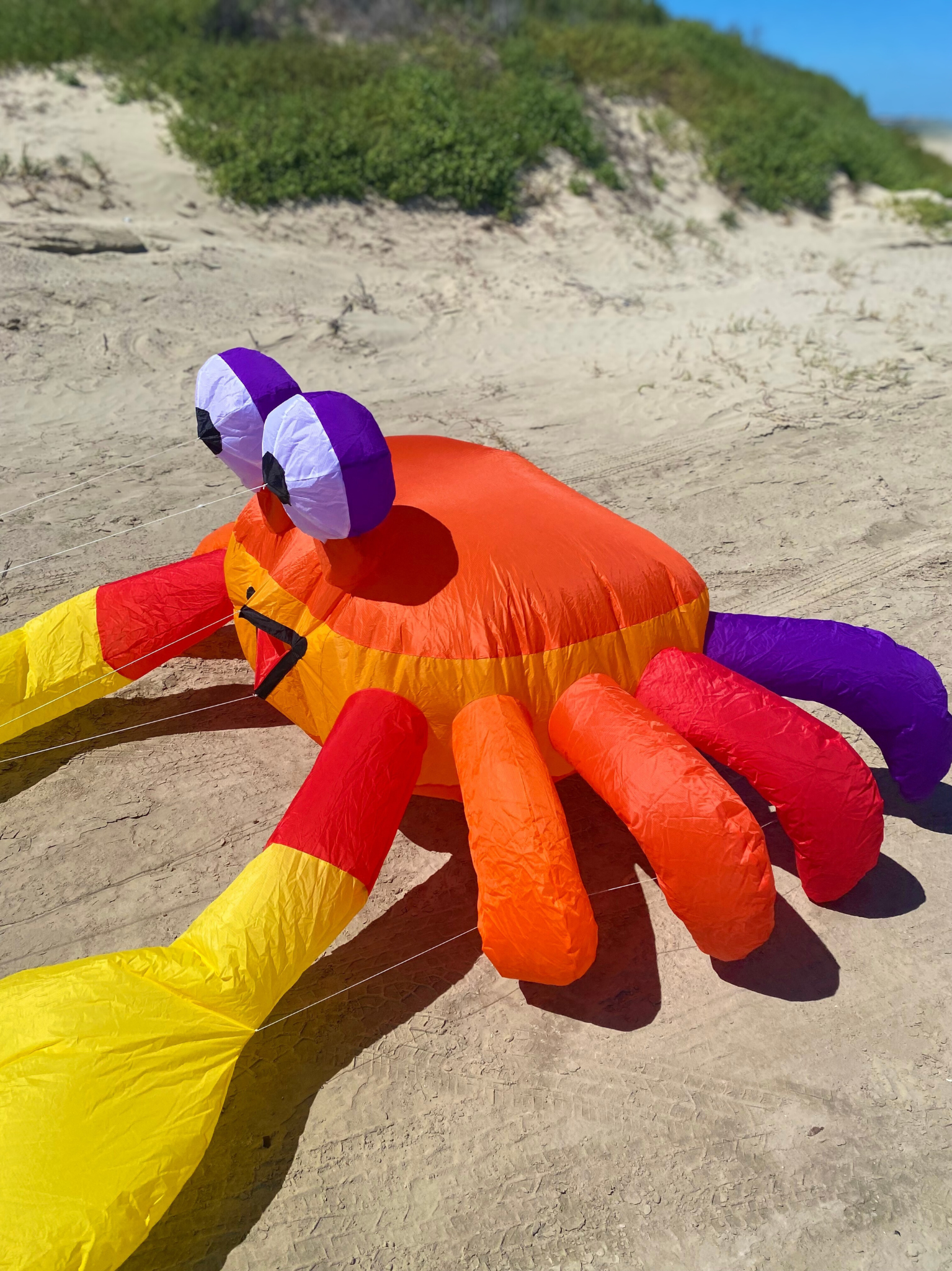 Inflatable crab kite on a sandy beach
