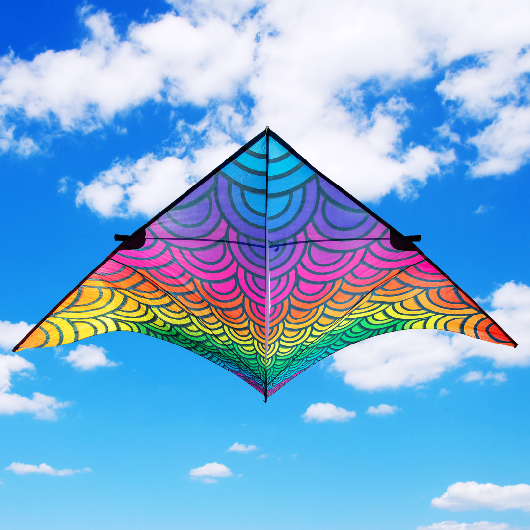 Colorful kite flying against a blue sky with white clouds