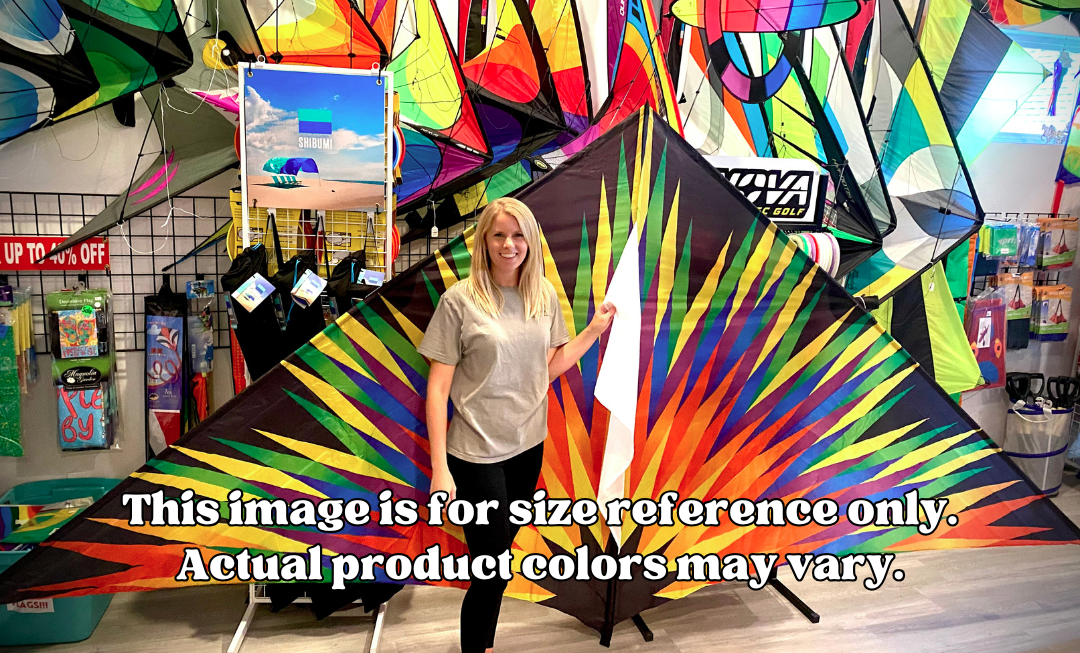 Woman standing next to a large colorful kite in a store setting with size reference text overlay.