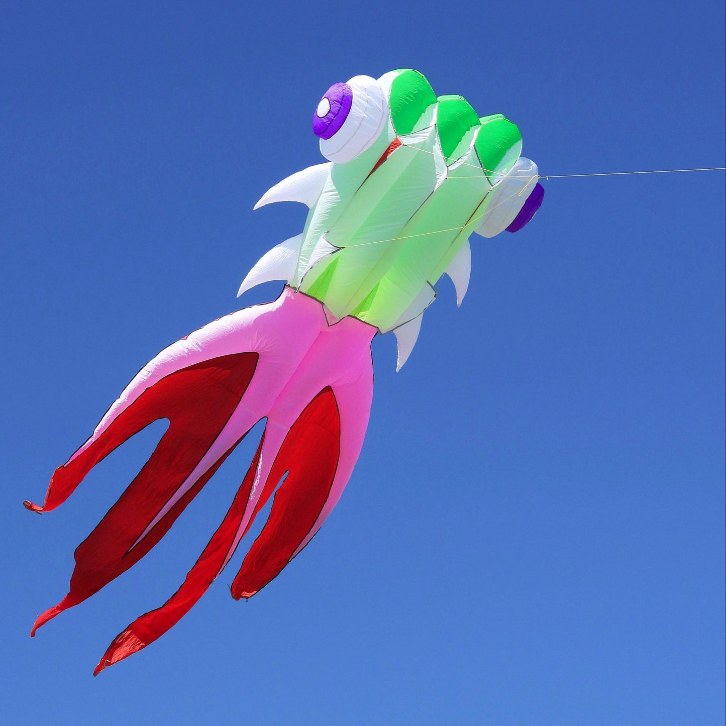 Colorful fish-shaped kite against a clear blue sky