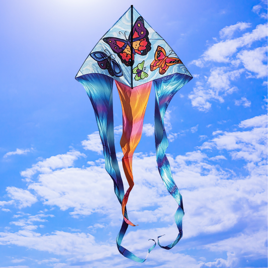 Colorful kite with butterfly designs against a blue sky with clouds