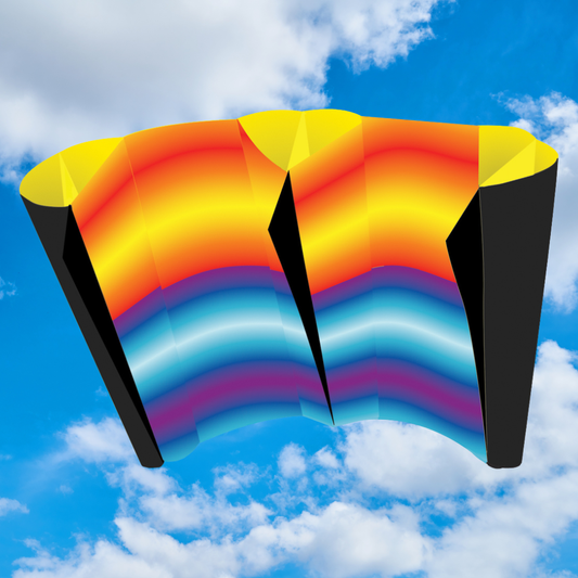 Colorful kite with a rainbow pattern against a blue sky with clouds