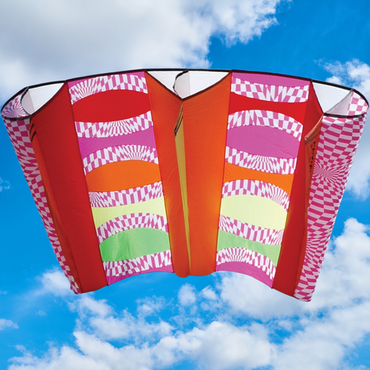 Colorful kite with geometric pattern against a blue sky
