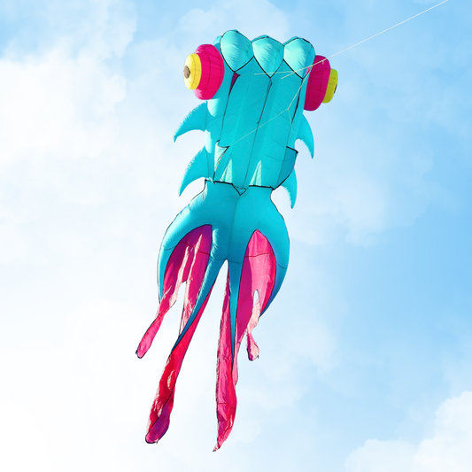 Colorful kite shaped like a fish against a blue sky