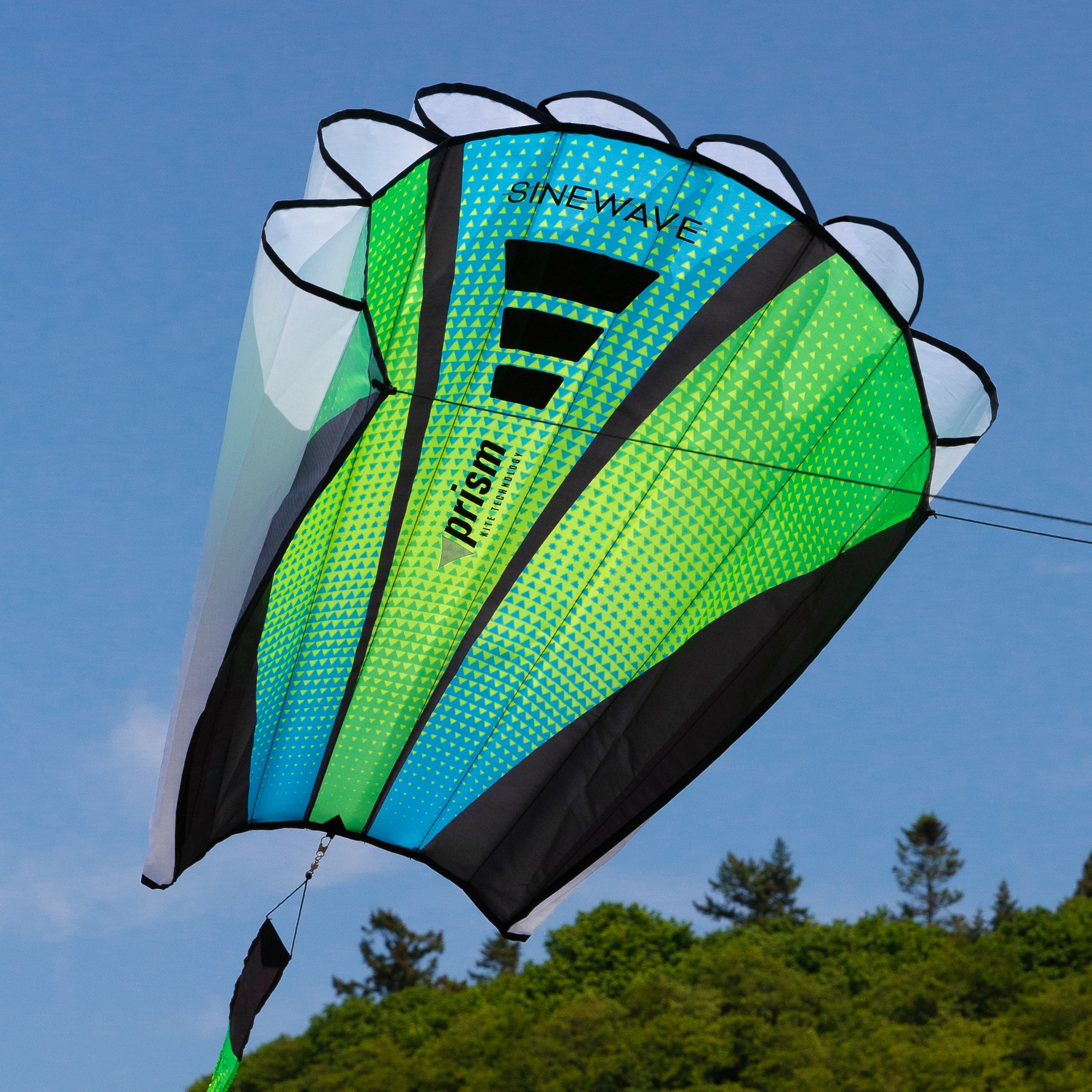 Colorful kite with 'SineWave' and 'Prism' branding against a blue sky.