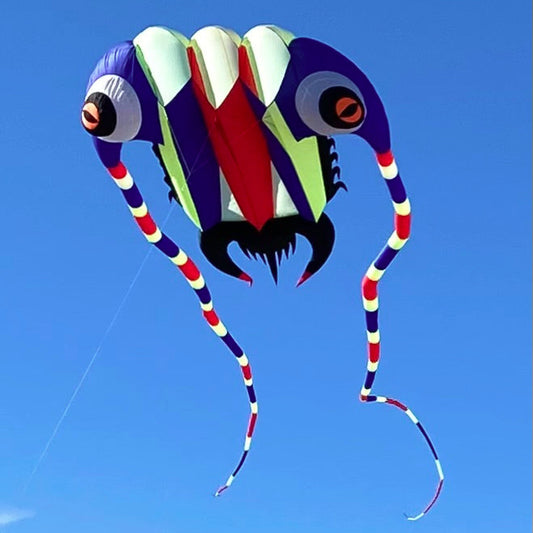 Colorful kite shaped like a trilobite against a clear blue sky