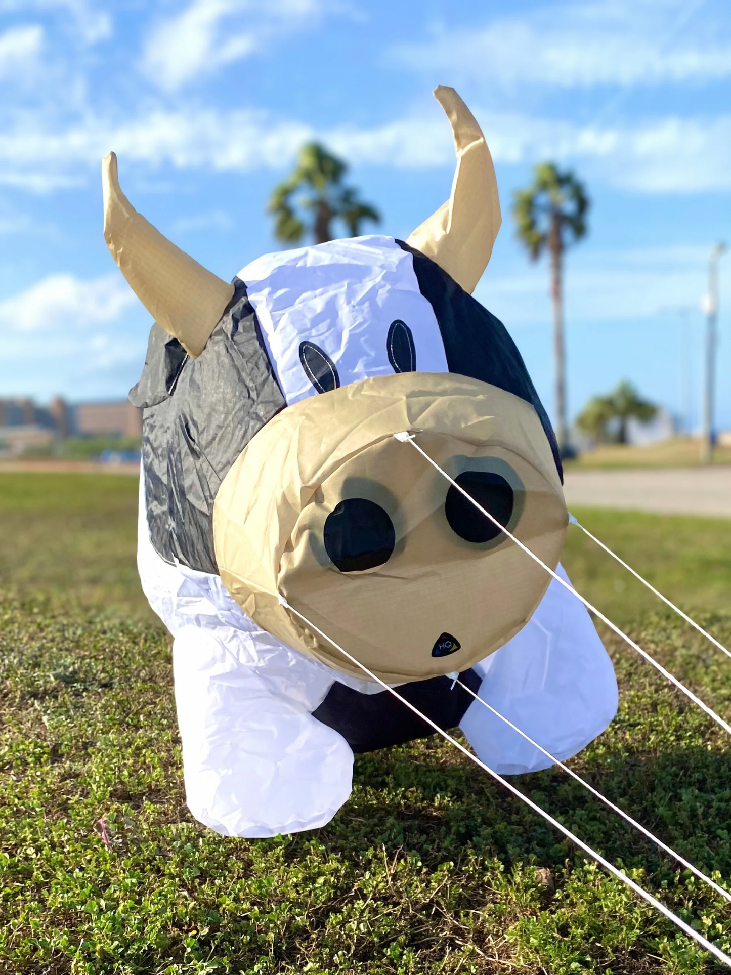 Inflatable cow with horns on a grassy field