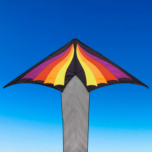 Colorful kite with a gradient design against a clear blue sky