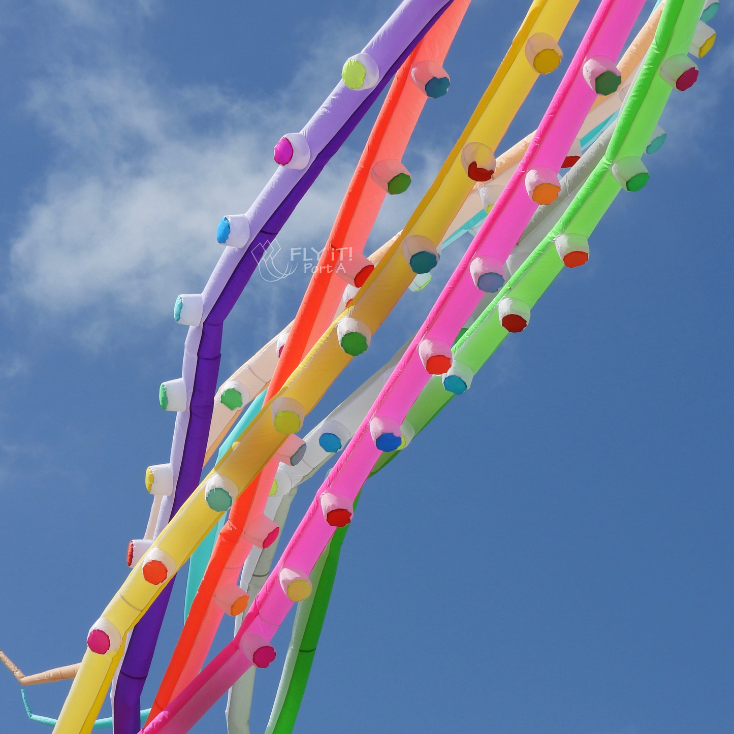 Colorful octopus kite legs against a blue sky