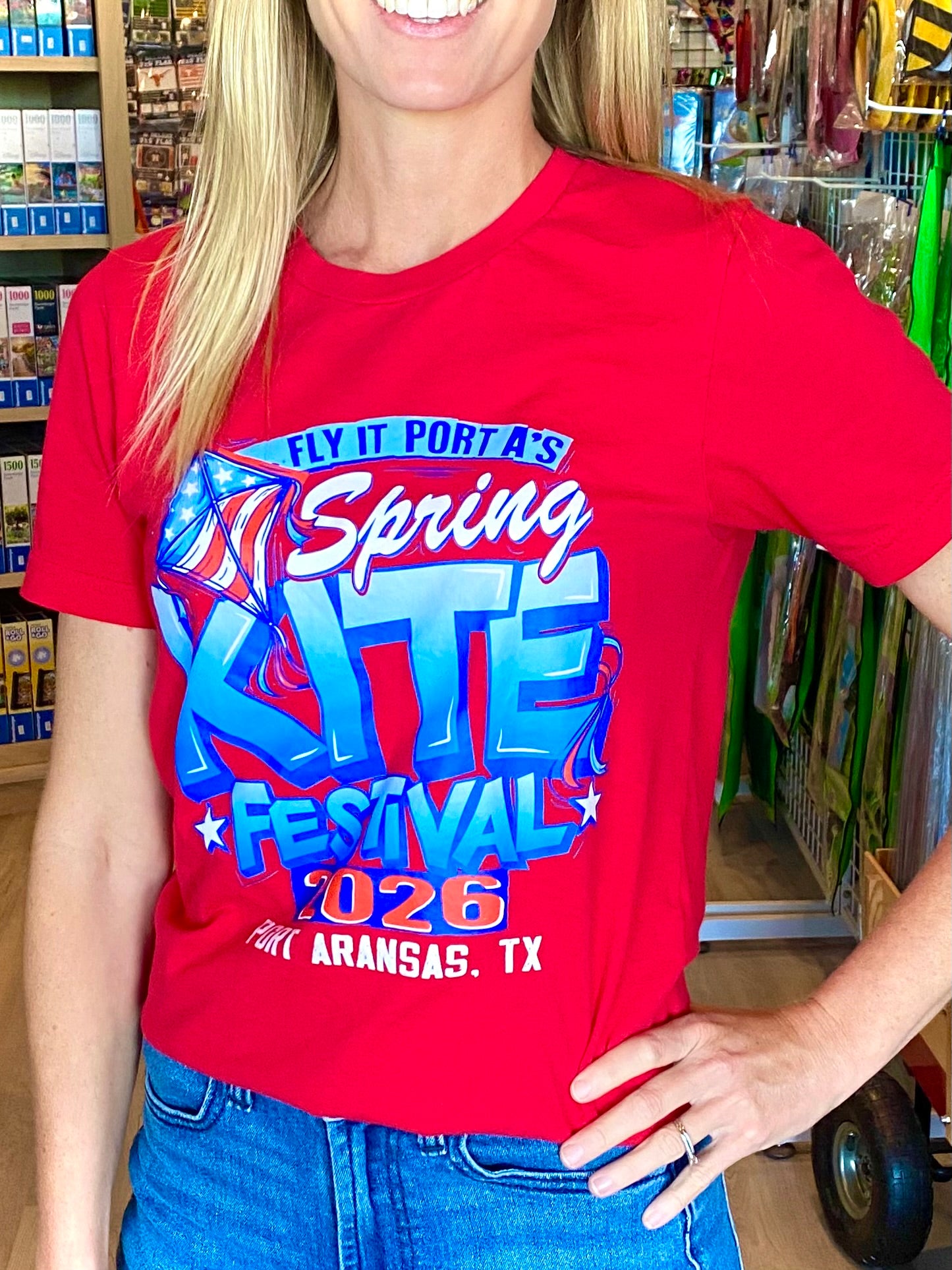 Person wearing a red t-shirt with 'Spring Zite Festival 2026' text in a store setting