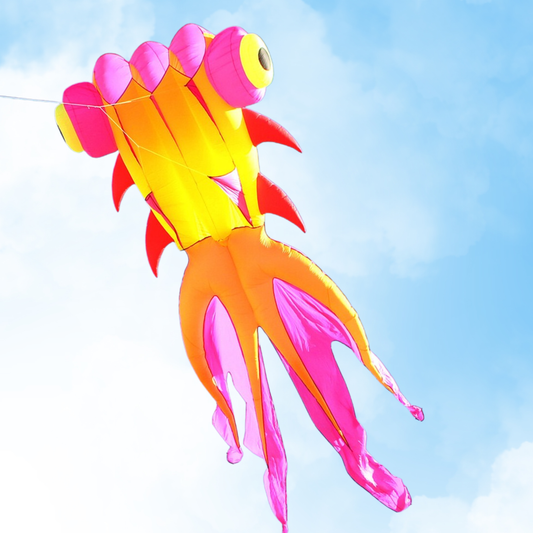 Colorful kite shaped like a fish against a clear blue sky