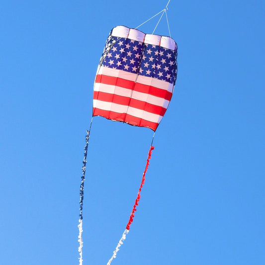 American flag kite flying against a clear blue sky