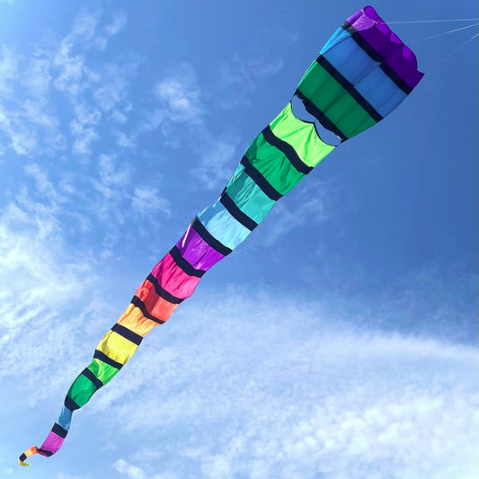 Colorful kite with a long tail against a blue sky