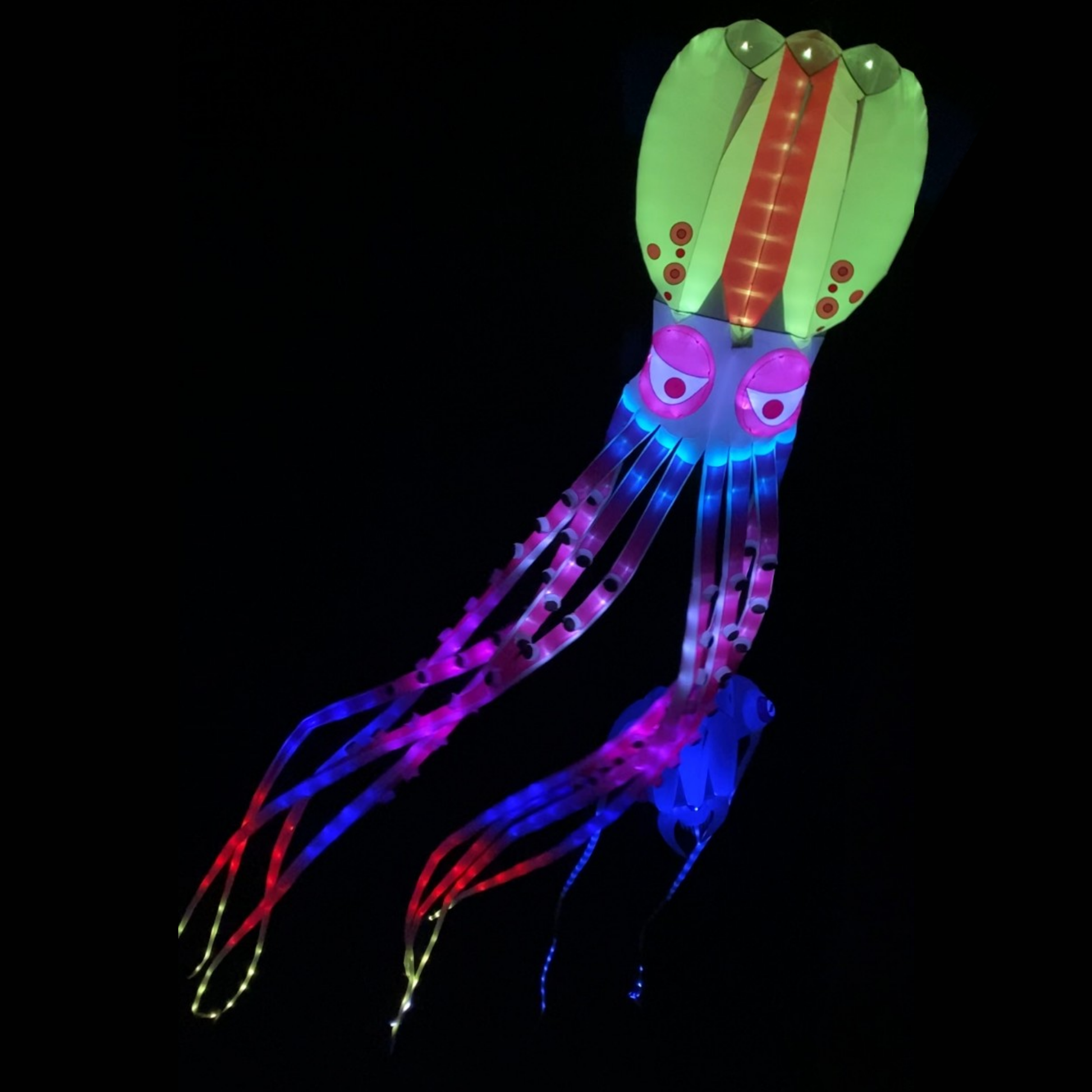 Colorful LED squid-shaped light up kite on a black background