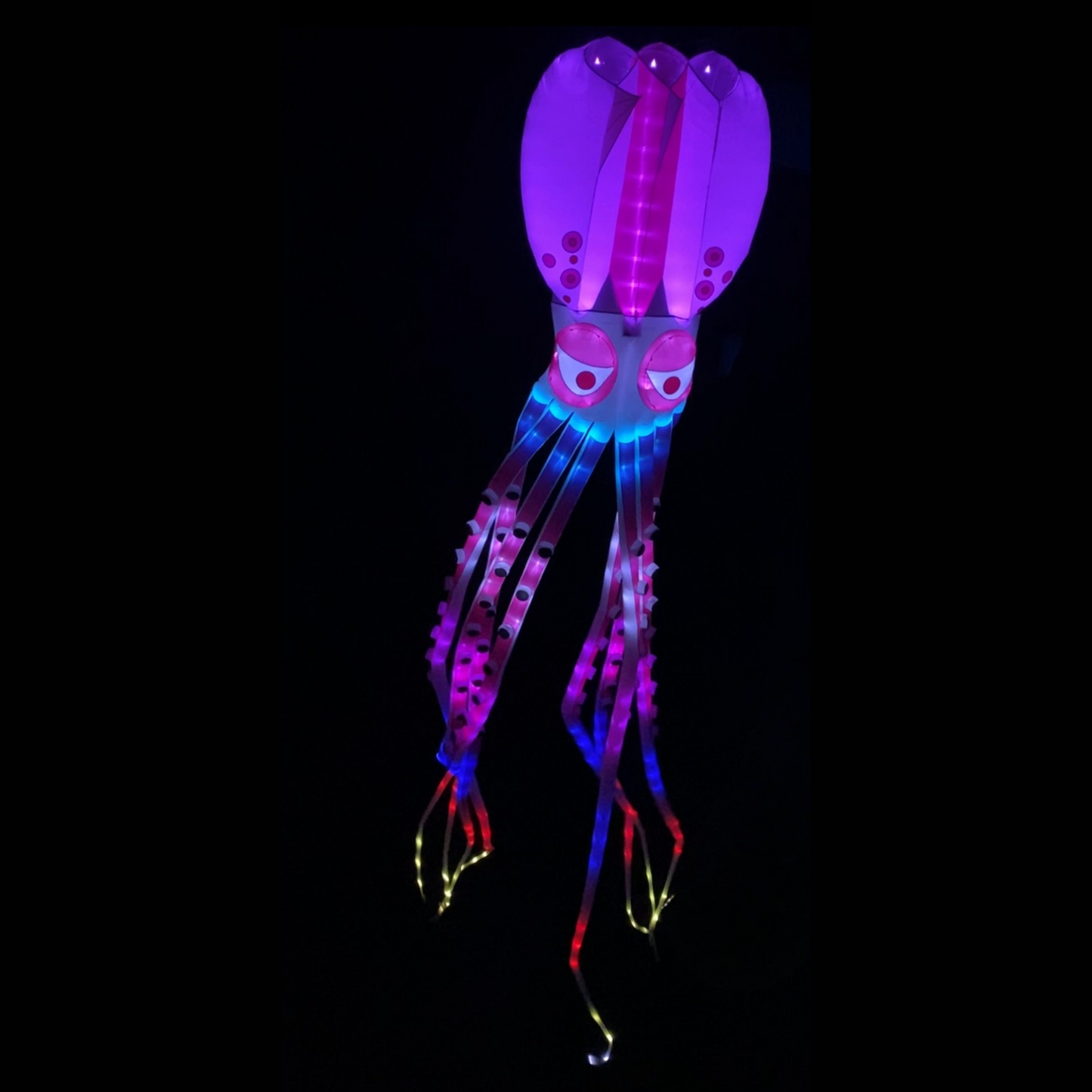 Colorful LED octopus kite on a black background