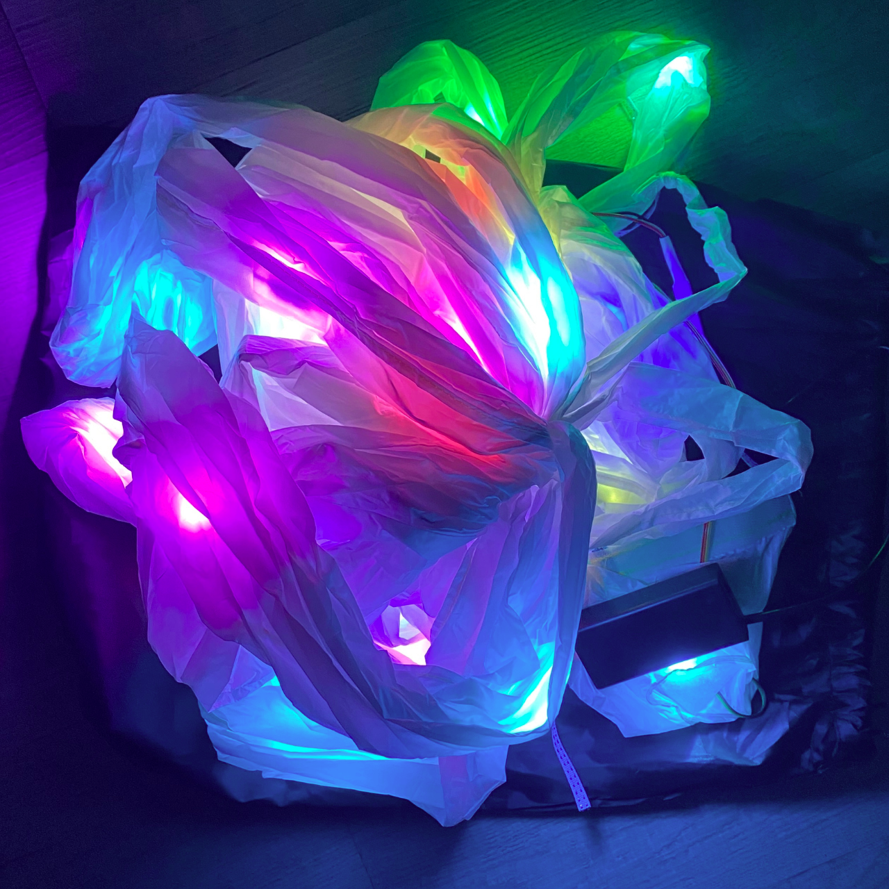 Multicolored LED string lights on a wooden floor