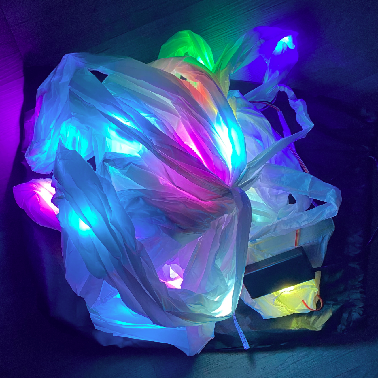 Multicolored LED string lights on a wooden floor