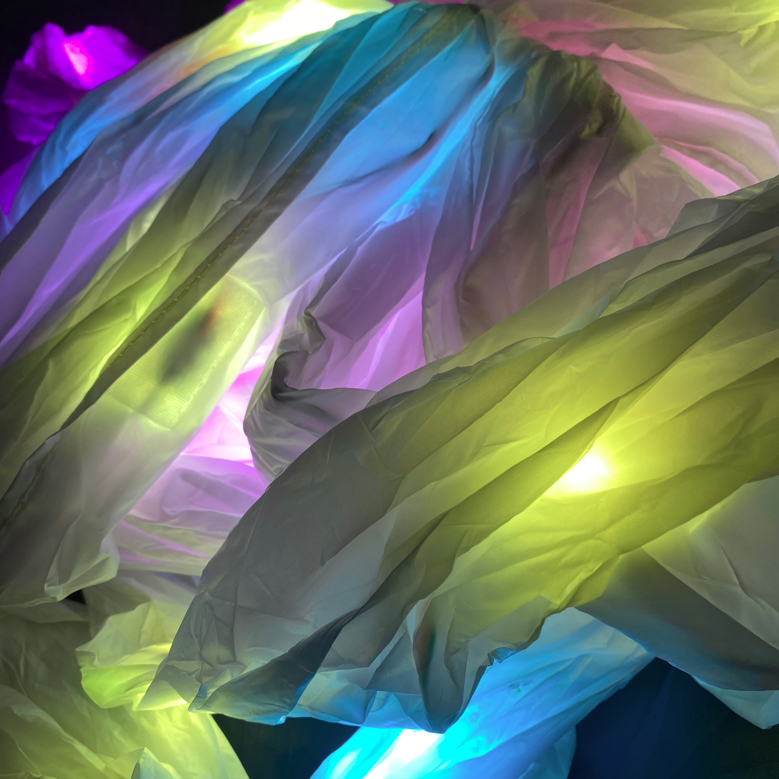 Close up of multicolored LED string lights on a wooden floor