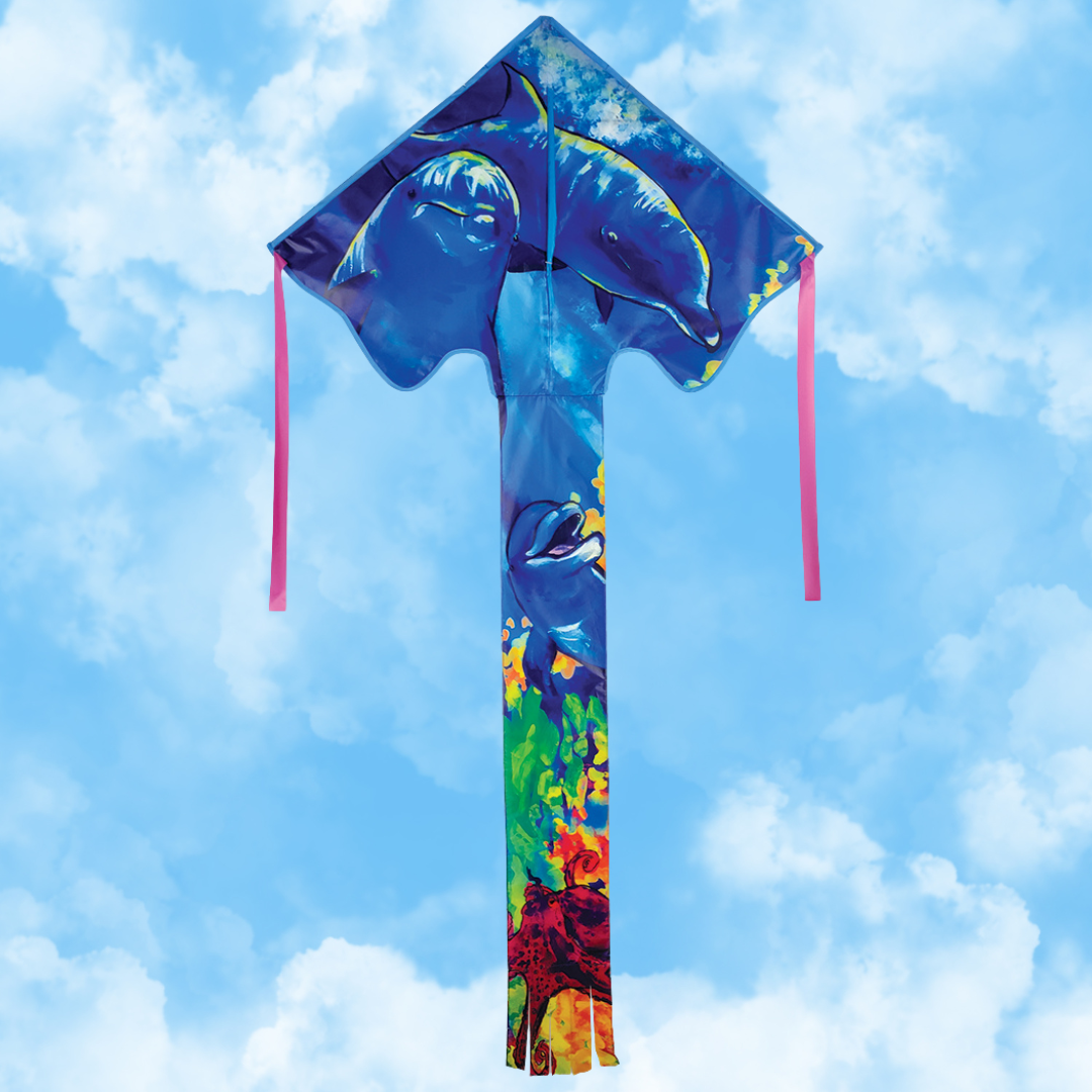 Colorful kite with dolphin design against a blue sky