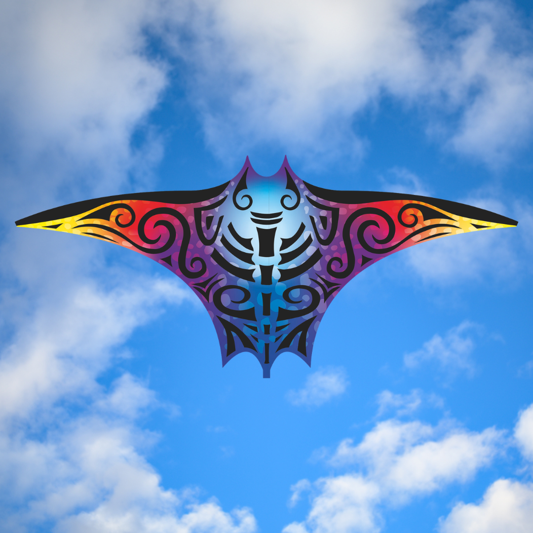 Colorful manta ray-shaped kite against a blue sky with clouds