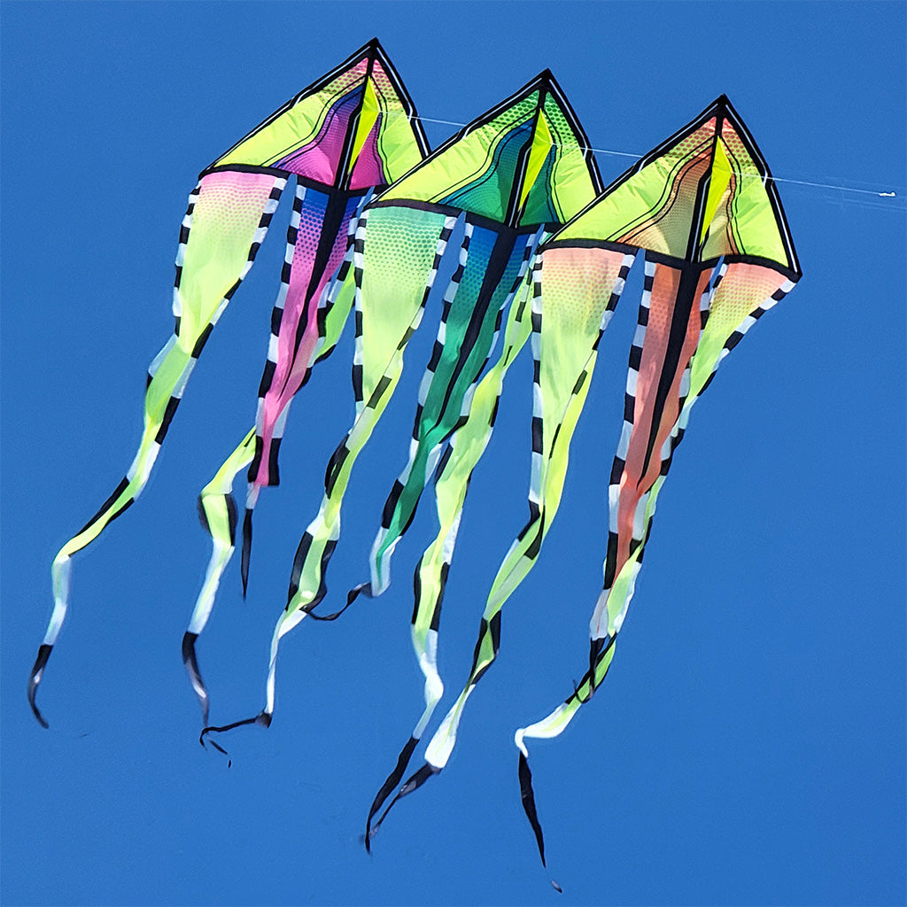Three colorful kites flying against a clear blue sky