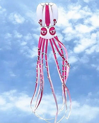 Pink and white squid-shaped kite against a blue sky with clouds