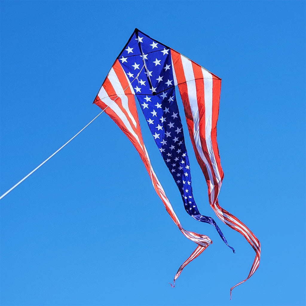 American flag kite against a clear blue sky