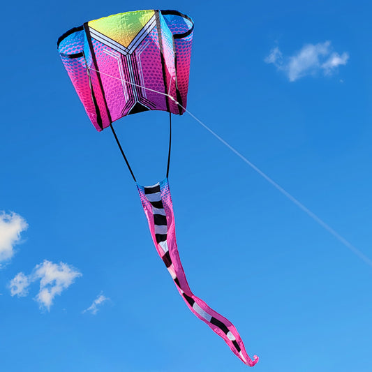 Colorful kite with a pink and black tail against a blue sky