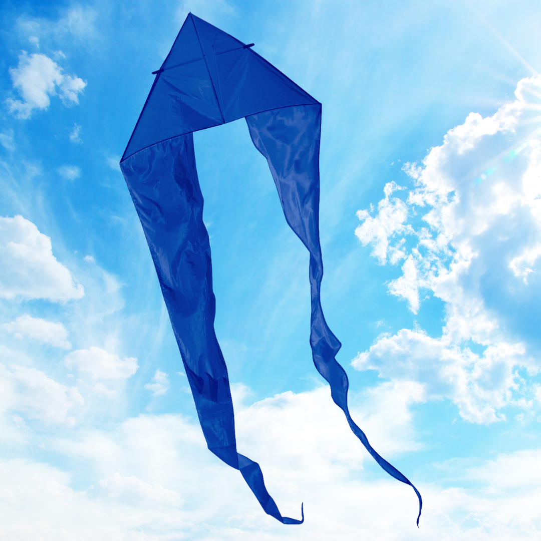 Blue kite with a long tail against a blue sky with clouds