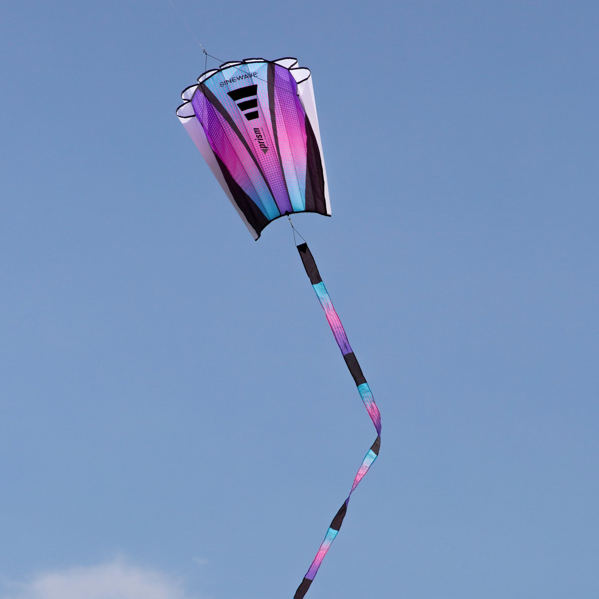 Colorful kite flying against a clear blue sky