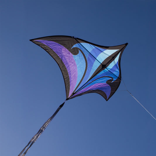 Colorful kite with a blue and purple design against a clear blue sky