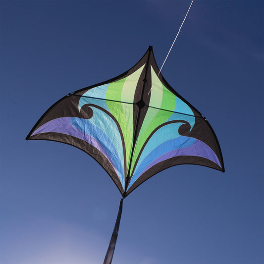 Colorful kite with a blue and green design against a clear blue sky