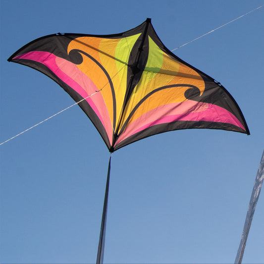 Colorful kite flying against a clear blue sky.