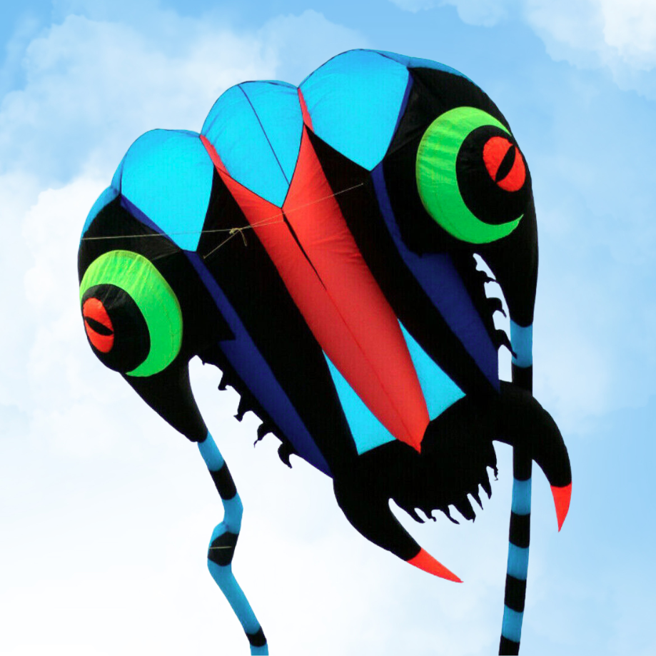 Colorful kite shaped like a trilobite against a blue sky