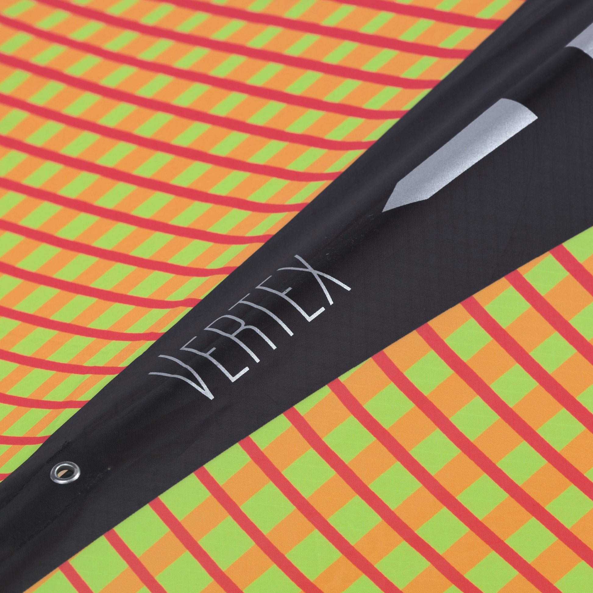 Close up of a Vertex diamond kite with 'Vertex' branding on a colorful geometric background