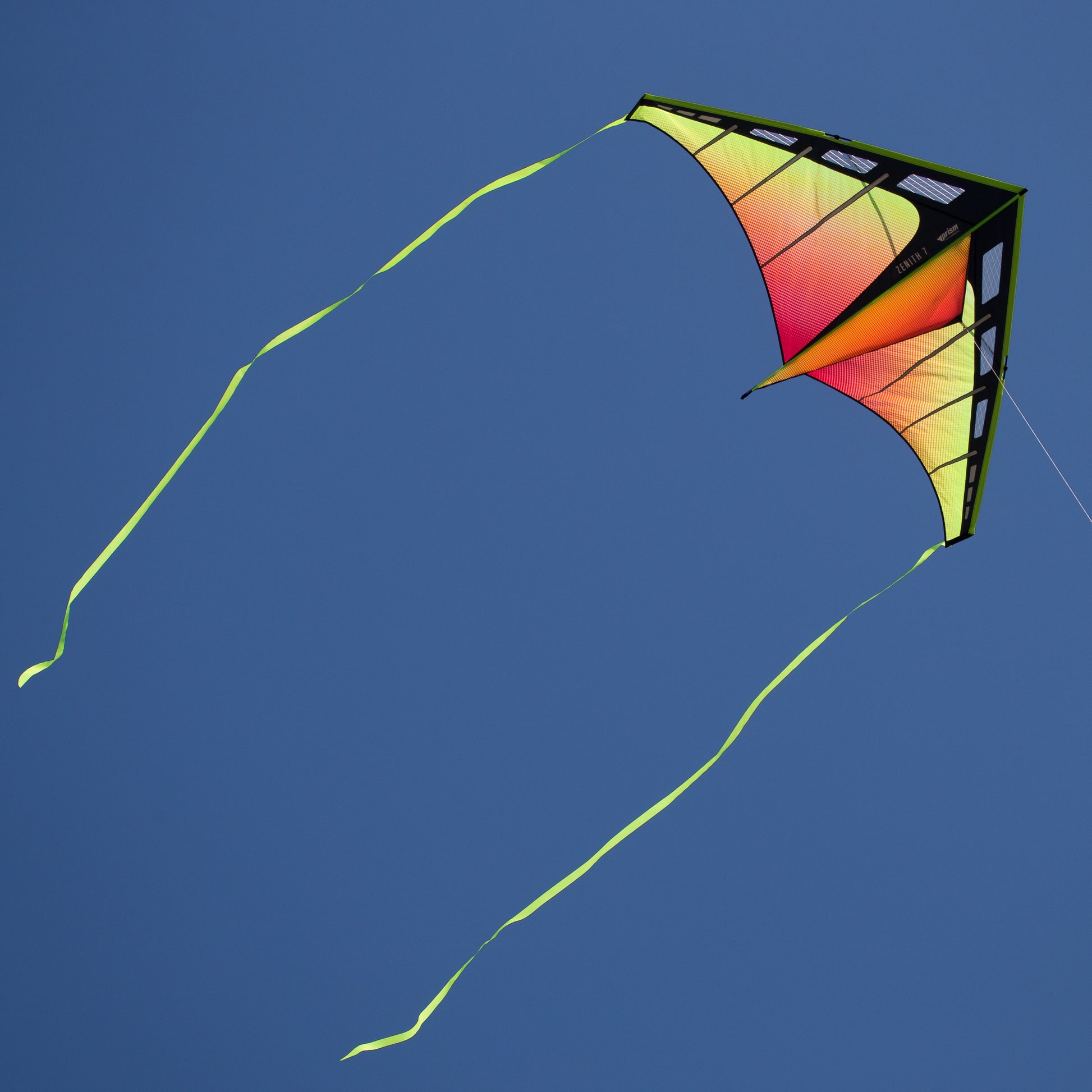 Colorful kite flying against a clear blue sky