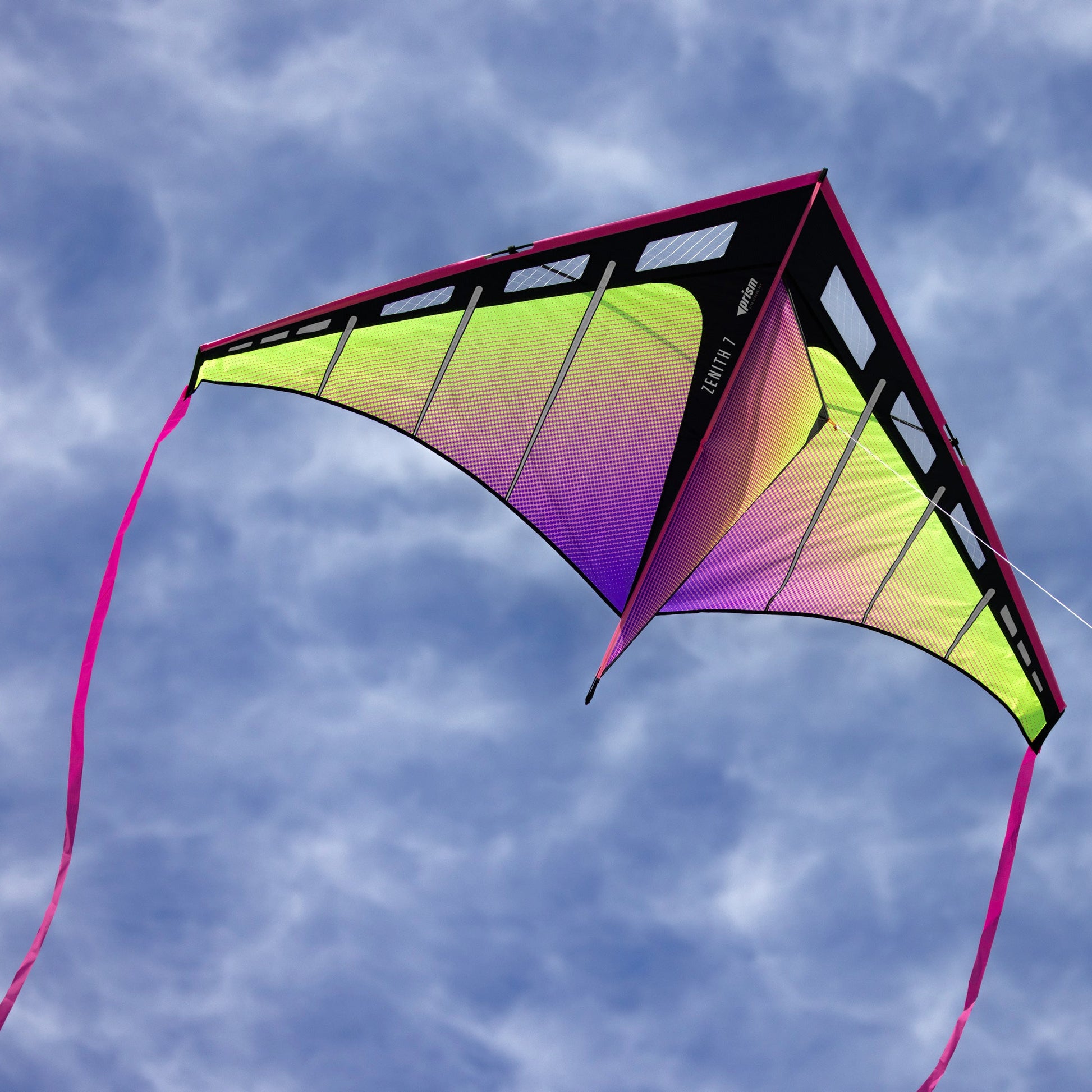 Colorful kite flying against a blue sky with clouds