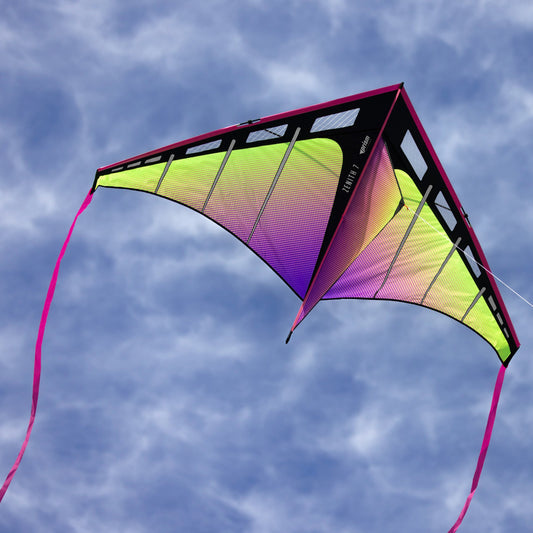 Colorful kite flying against a blue sky with clouds